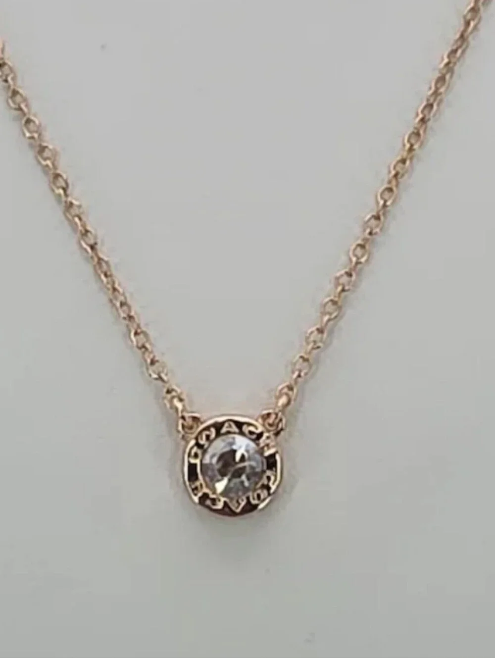 COACH Rose Gold Crystal Logo Disc Necklace
